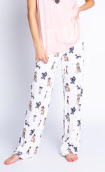 Load image into Gallery viewer, Front view of the bottom half of a woman wearing the PJ Salvage Love &amp; Dogs pajama pant with a mix of hipster dogs printed on it.
