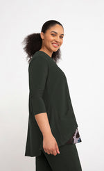 Load image into Gallery viewer, Right side top half view of a woman wearing the sympli nu whisper split back top. This top is in the color green/seaweed with a mineral print peeking out from the bottom. The top has 3/4 length sleeves and a round neck.
