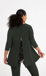 Load image into Gallery viewer, Back top half view of a woman wearing the sympli nu whisper split back top. This top is in the color green/seaweed with a mineral print peeking out from behind a slit in the back. The top has 3/4 length sleeves and a round neck.
